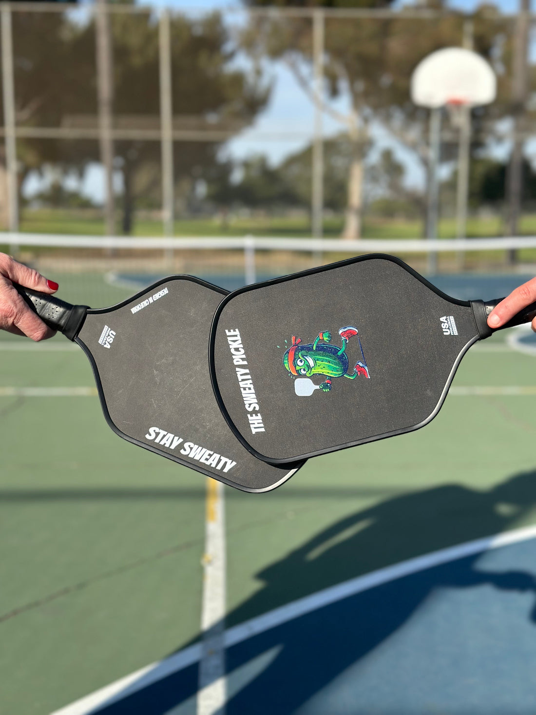 Two Carbon Fiber Pickleball paddles after a victory