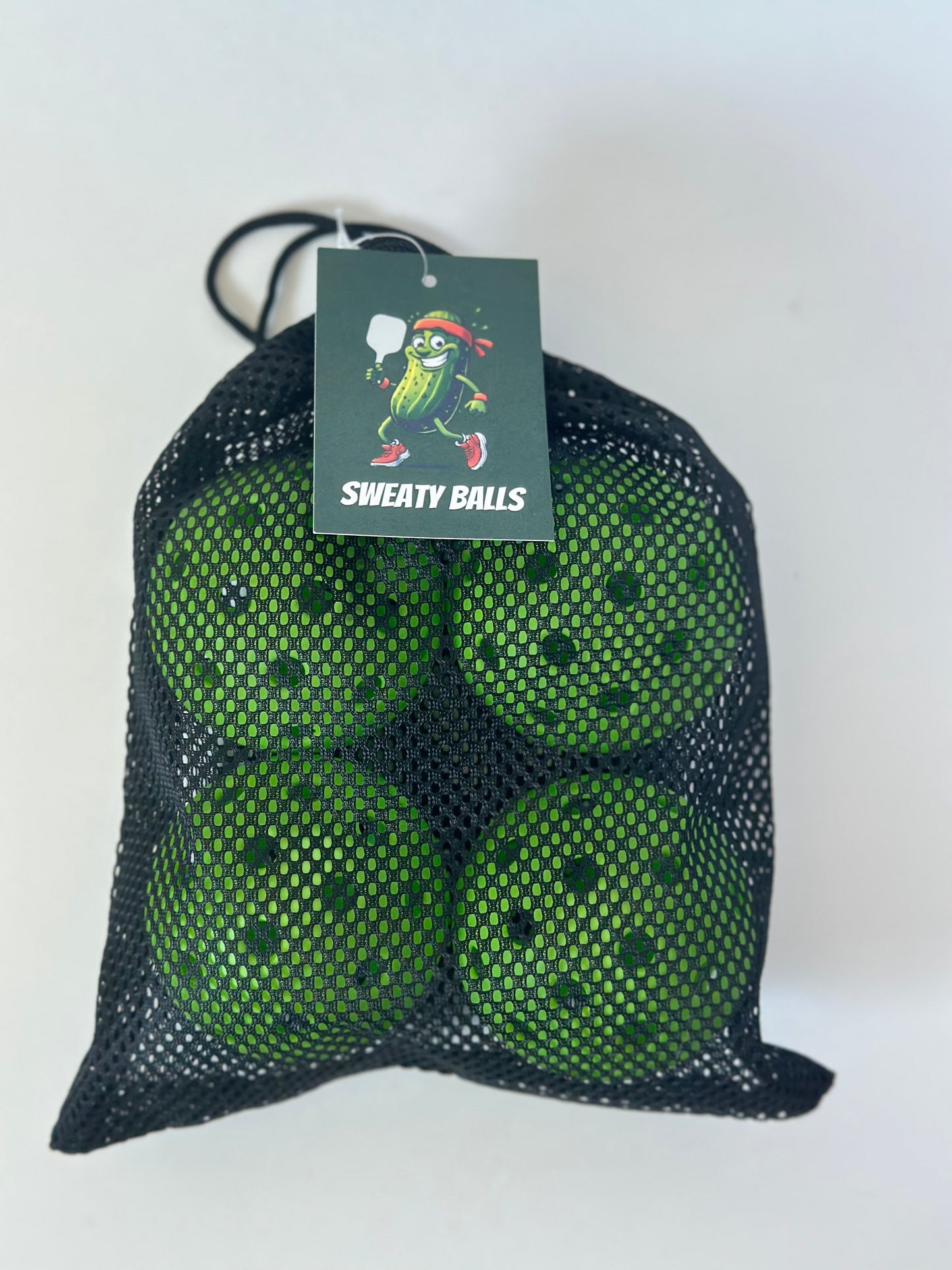 Four-pack of The Sweaty Pickle pickleballs in branded packaging